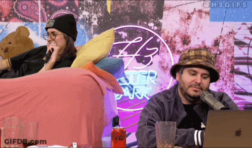 Two People Sitting In Front Of 43 Ster Park Sign GIF