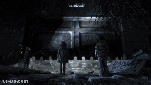 Two People Standing Before Danger Ghost Sign GIF