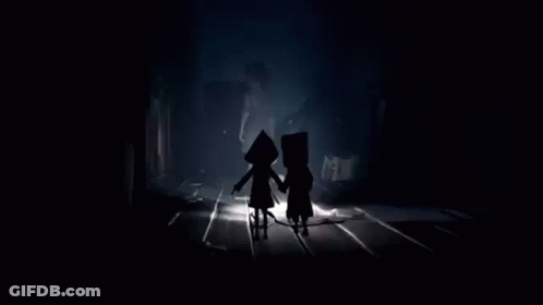 Two People Standing In Dark Room GIF