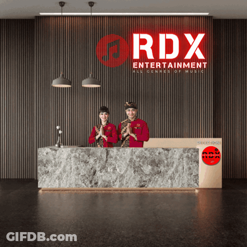 Two People Standing In Front Of A Sign That Says Rdx GIF