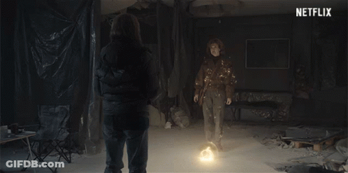 Two People Standing In Room With Netflix Logo GIF