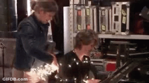 Two People Standing In Room GIF