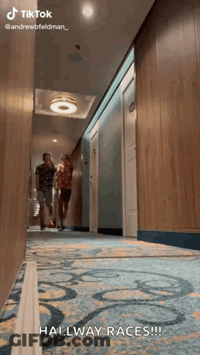 Two People Walking Down Hallway Hallway Races GIF