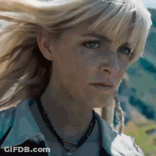 Two People Walking In Grassy Field With Number 03 GIF