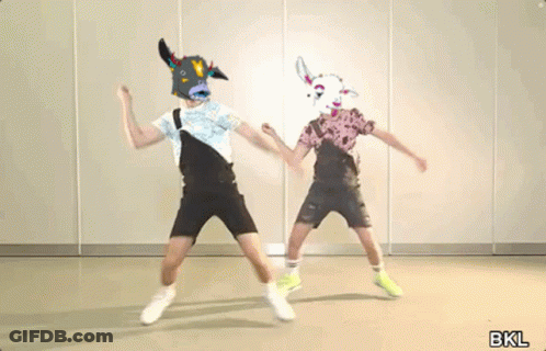 Two People Wearing Cow Masks Dancing In Room GIF