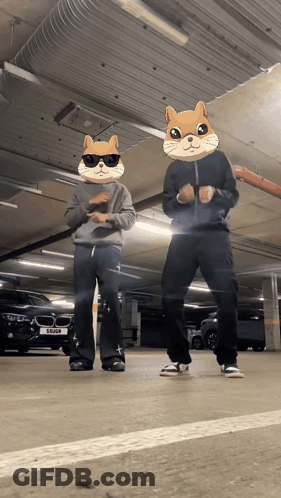 Two People Wearing Hamster Masks Are Dancing In A Garage GIF