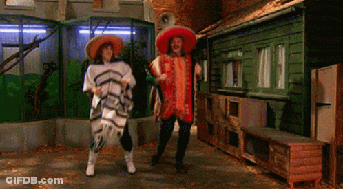 Two People Wearing Sombrero 'S Are Dancing In A Room GIF