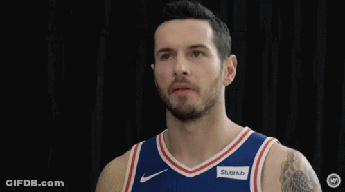 Two Philadelphia 76Ers Players Are Standing Next To Each Other And Smiling . GIF
