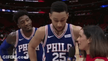 Two Philadelphia 76Ers Players Are Talking To A Reporter On The Court GIF