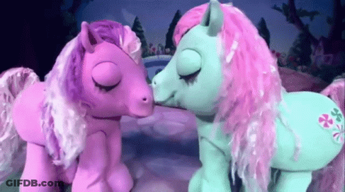 Two Pink And Blue Ponies Are Kissing Each Other GIF