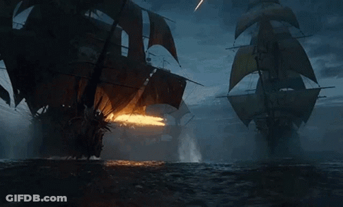 Two Pirate Ships Fighting At Night GIF
