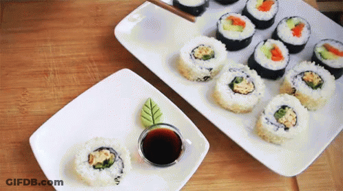 Two Plates Of Sushi With Soy Sauce GIF