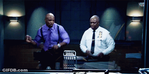 Two Police Officers Are Dancing In A Dark Room And One Has A Nyps Patch On His Shirt GIF