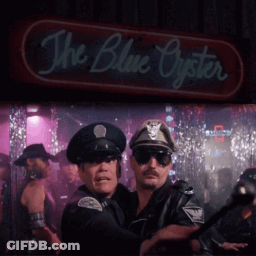 Two Police Officers Are Standing In Front Of A Neon Sign That Says The Blue Oyster GIF