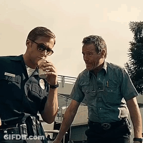 Two Police Officers Are Standing Next To Each Other One Of Whom Has A Name Tag That Says Marcus GIF