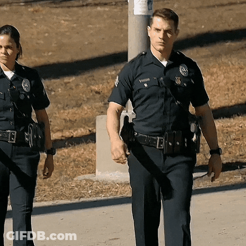 Police Officers Walking With Williamson Badge GIF