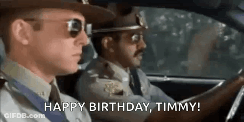 Two Police Officers Driving Car Saying Happy Birthday Timmy GIF