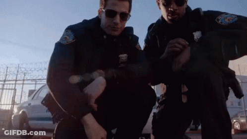 Two Police Officers Kneeling GIF