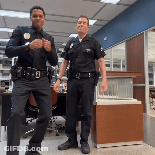 Two Police Officers One With L.A. Badge GIF