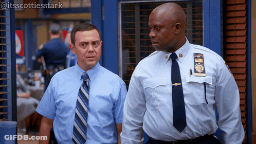Two Police Officers One With NYPD Badge GIF