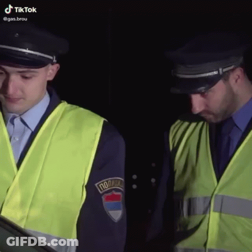 Two Police Officers One With Policija Patch GIF