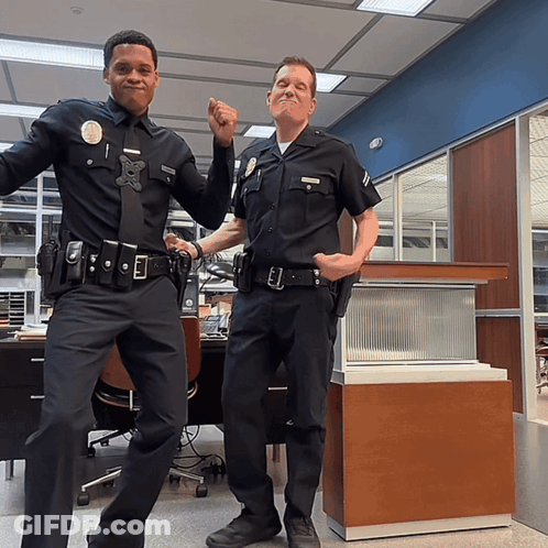 Two Police Officers Posing With Number 1 GIF