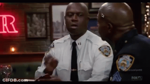 Two Police Officers Standing In Bar Talking GIF