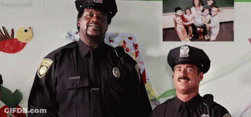 Two Police Officers Standing Next To Wall Of Children GIF