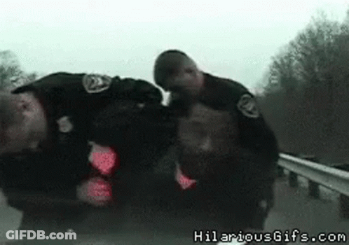 Two Police Officers Standing Together With Hilariousgifs.com Watermark GIF