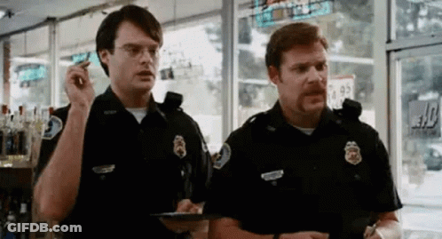 Two Police Officers Talking In Store GIF