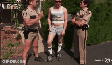 Two Police Officers Talking To A Man In Shorts And Socks GIF