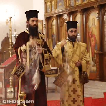Two Priests Are Standing In A Church And One Of Them Has A Cross On His Robe GIF