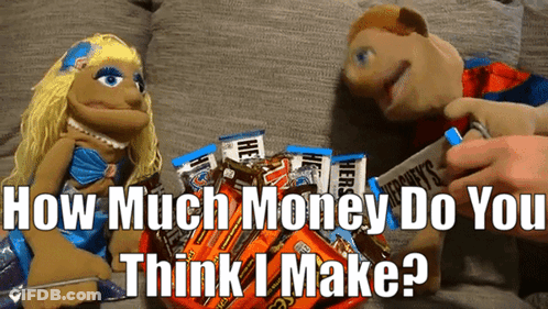 Two Puppets Are Sitting Next To A Pile Of Hershey 'S Bars GIF
