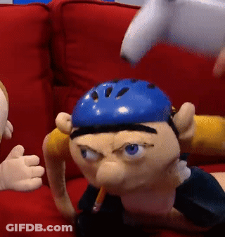 Two Puppets On Red Couch, One With Blue Helmet GIF