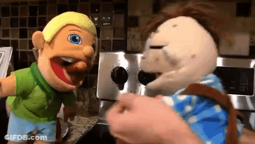 Two Puppets Standing Next To Each Other In Kitchen GIF
