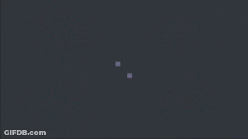 Two Purple Squares Are Floating In The Dark On A Dark Background . GIF