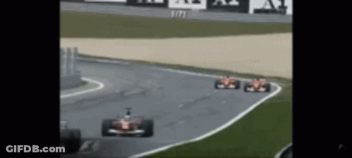 Two Race Cars Racing On Track GIF