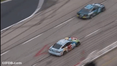 Two Race Cars Racing On Track With Large Logo GIF