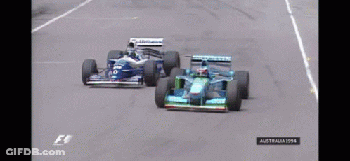 Two Racing Cars On A Race Track With The Year 1994 On The Bottom GIF
