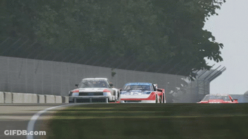 Two Racing Cars On Track With Goodyear GIF