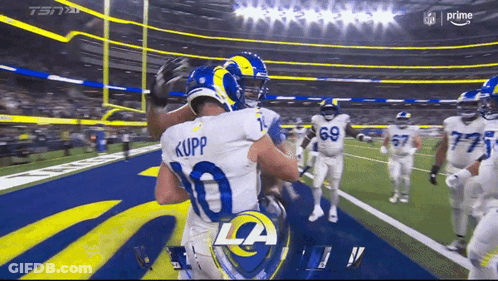 Two Rams Players Hugging Each Other On The Field GIF