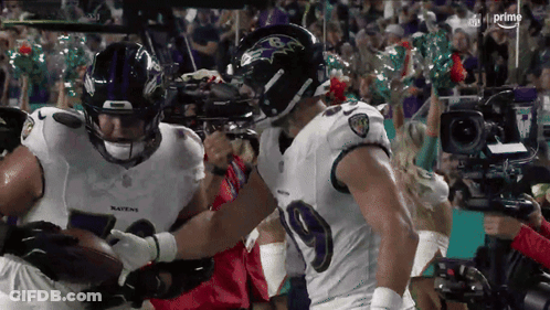 Two Ravens Football Players Holding Ball GIF