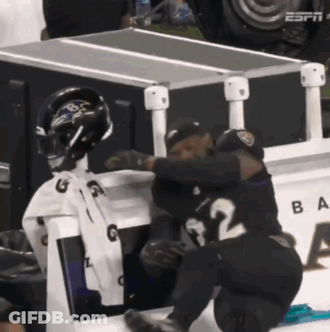 Two Ravens Players Hugging In Front Of ESPN Box GIF