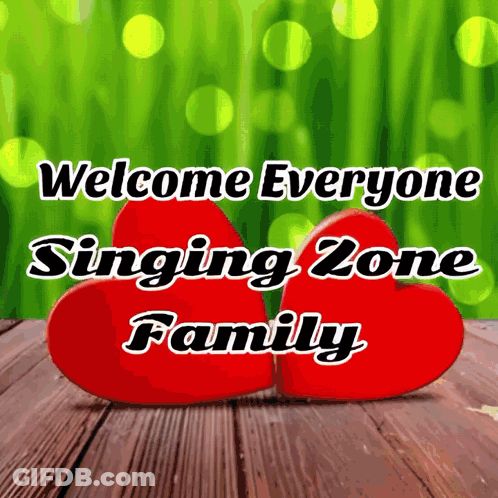 Two Red Hearts On A Wooden Table With The Words Welcome Everyone Singing Zone Family Below Them GIF
