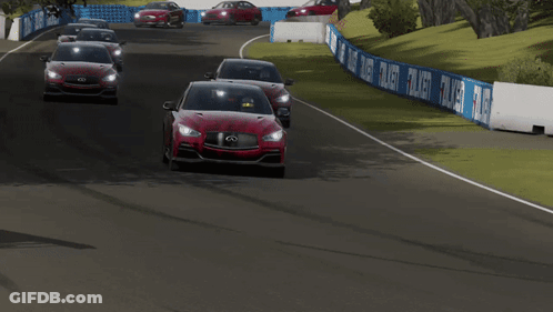 Two Red Infiniti Cars Are Driving On A Track GIF
