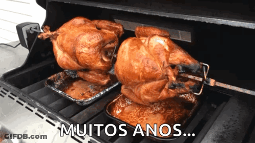 Two Roasted Turkeys On A Grill With The Words " Muitos Anos " Written Below Them GIF