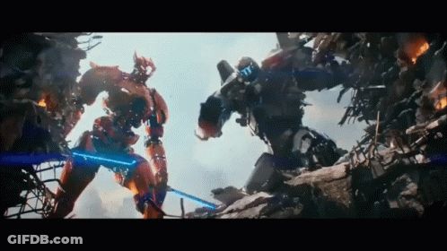 Two Robots Are Fighting Each Other And One Has A Blue Light On GIF