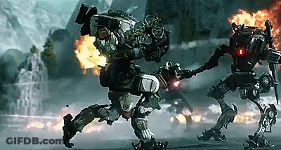 Two Robots Are Fighting Each Other In Front Of A Fire GIF