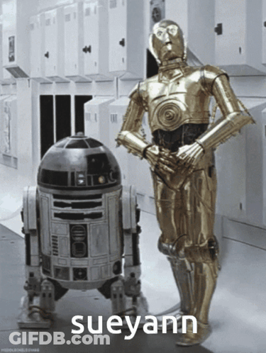 Two Robots Standing Next To Each Other GIF