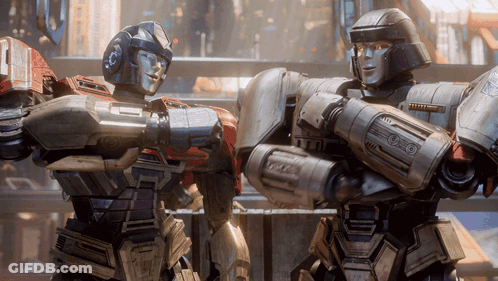 Two Robots Standing Together With Letter O GIF